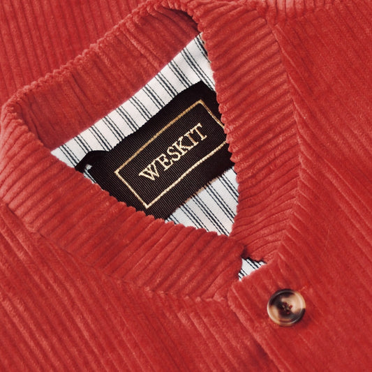 Nehru Collar Detail showing striped cotton ticking lining and embroidered label on fitted Nehru-Style Gilet in Claret Corduroy. This pure cotton corduroy gilet has five pockets, neat shaping at the waist to give a nicely tailored look and a five buttoned front. Handmade in London.