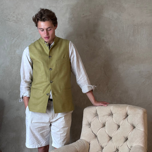 Relaxed fit summer weight gilet in green silk weave. Handmade in London this gilet has a Mandarin collar and is fully lined in pure cotton ticking. Made in Great Britain. Buttoned up shot.