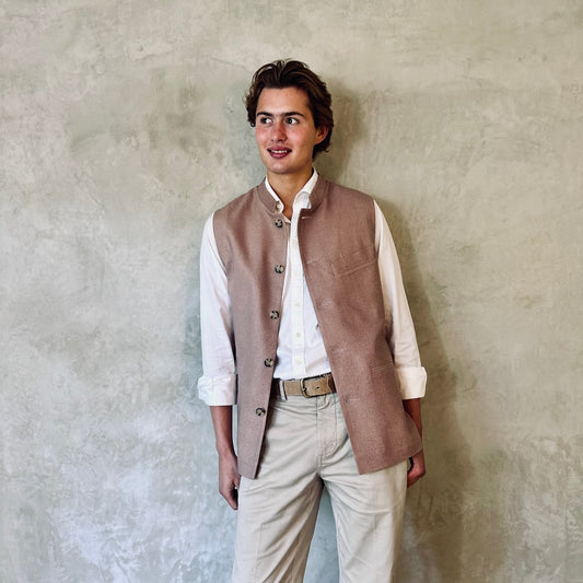 Slim fit Nehru style gilet for spring summer wear. Handmade in London this purse silk waistcoat is fully lined, has a Nehru collar and five corozo buttons to the front. With three outside and two inside pockets it is a perfect alternative to a jacket in summer. Pale Pink. Front open shot.