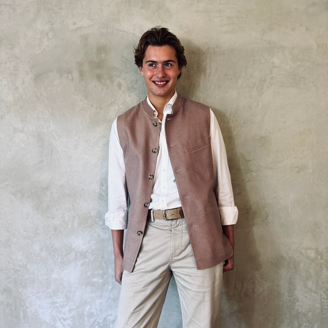 Slim fit Nehru style gilet for spring summer wear. Handmade in London this purse silk waistcoat is fully lined, has a Nehru collar and five corozo buttons to the front. With three outside and two inside pockets it is a perfect alternative to a jacket in summer. Pale Pink. Front open shot.