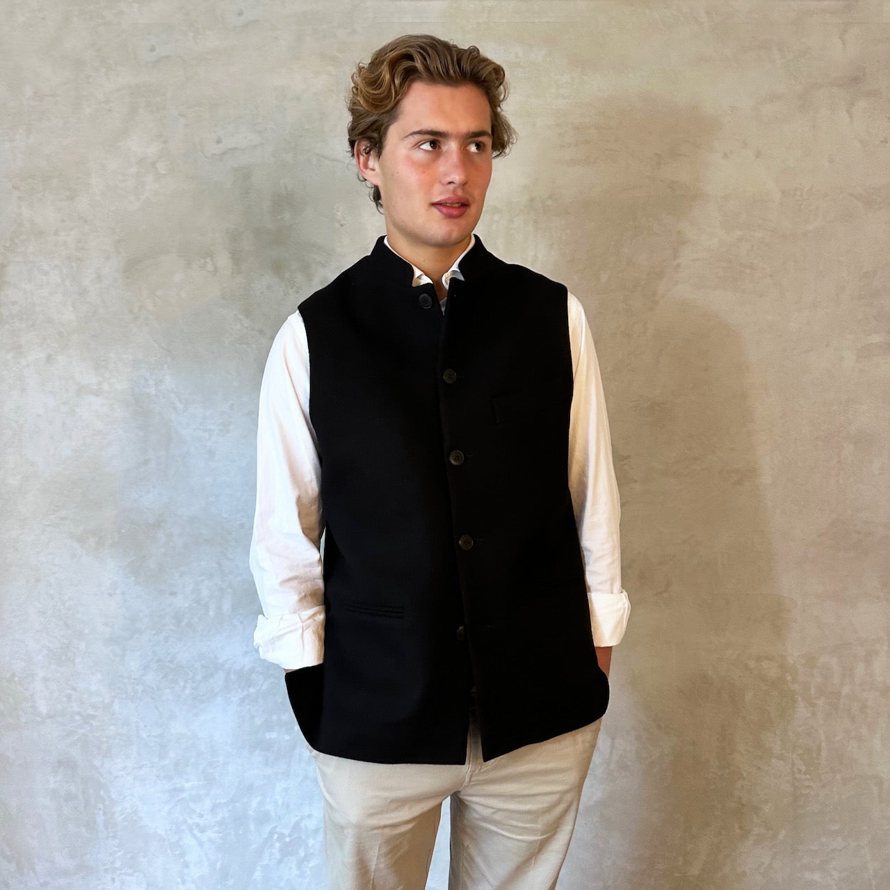 A luxurious pure merino wool flannel Nehru Style gilet. Handmade in London, the gilet has a Nehru Collar, five buttons down the front, three outer pockets and two inside pockets. Woven in Yorkshire.
