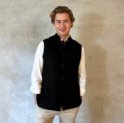 A luxurious pure merino wool flannel Nehru Style gilet. Handmade in London, the gilet has a Nehru Collar, five buttons down the front, three outer pockets and two inside pockets. Woven in Yorkshire.