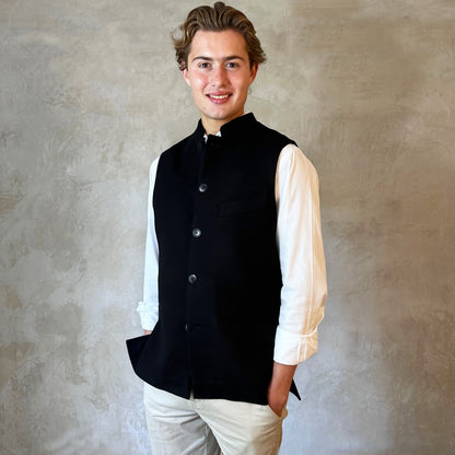 A luxurious pure merino wool flannel Nehru Style gilet. Handmade in London, the gilet has a Nehru Collar, five buttons down the front, three outer pockets and two inside pockets. Woven in Yorkshire.