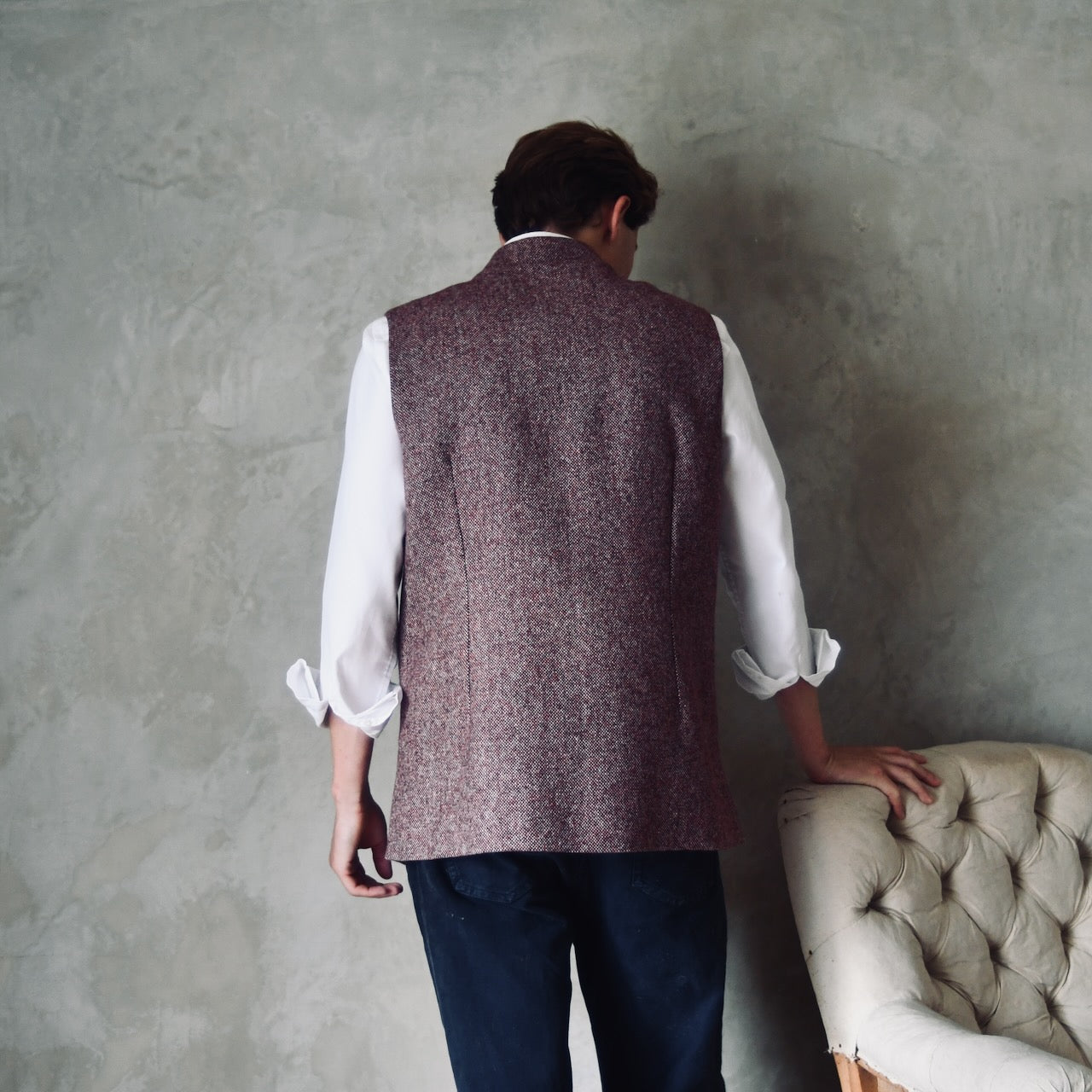 Rear Shot of a superb and wonderfully warm alternative to a jacket for autumn winter with a neat cut and ample pocket space. Sophisticated enough for Town, Warm enough for the Country.

This fitted cut waistcoat has five button-fronts and side vents for ease when moving and sitting. Fully lined, it has generous inside facings to avoid unsightly lining slippage.

Handmade in London.