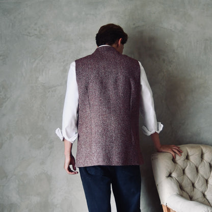 Rear Shot of a superb and wonderfully warm alternative to a jacket for autumn winter with a neat cut and ample pocket space. Sophisticated enough for Town, Warm enough for the Country.

This fitted cut waistcoat has five button-fronts and side vents for ease when moving and sitting. Fully lined, it has generous inside facings to avoid unsightly lining slippage.

Handmade in London.