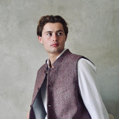A superb and wonderfully warm alternative to a jacket for autumn winter with a neat cut and ample pocket space. Sophisticated enough for Town, Warm enough for the Country.

This fitted cut waistcoat has five button-fronts and side vents for ease when moving and sitting. Fully lined, it has generous inside facings to avoid unsightly lining slippage.

Handmade in London.