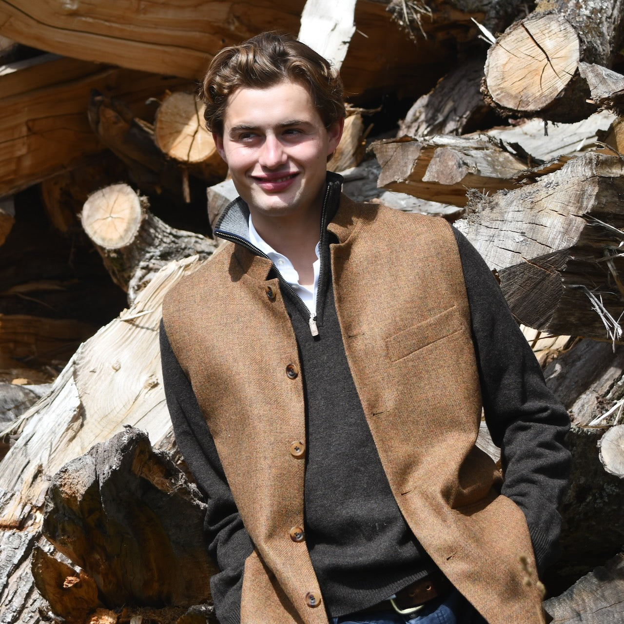 The perfect transitional piece. Fitted Nehru style gilet in a lovely orange brown Yorkshire tweed. Three outside and two inside pockets make this a splendid alternative to a jacket. It can be dressed up or down and the finely woven tweed will work as well in the city as in the country. Handmade in London.
