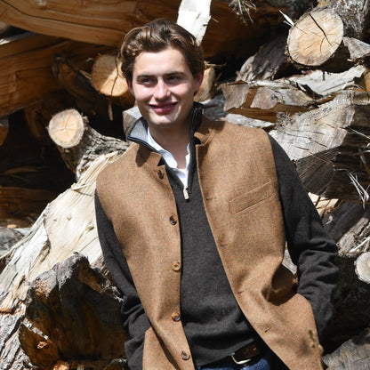 The perfect transitional piece. Fitted Nehru style gilet in a lovely orange brown Yorkshire tweed. Three outside and two inside pockets make this a splendid alternative to a jacket. It can be dressed up or down and the finely woven tweed will work as well in the city as in the country. Handmade in London.