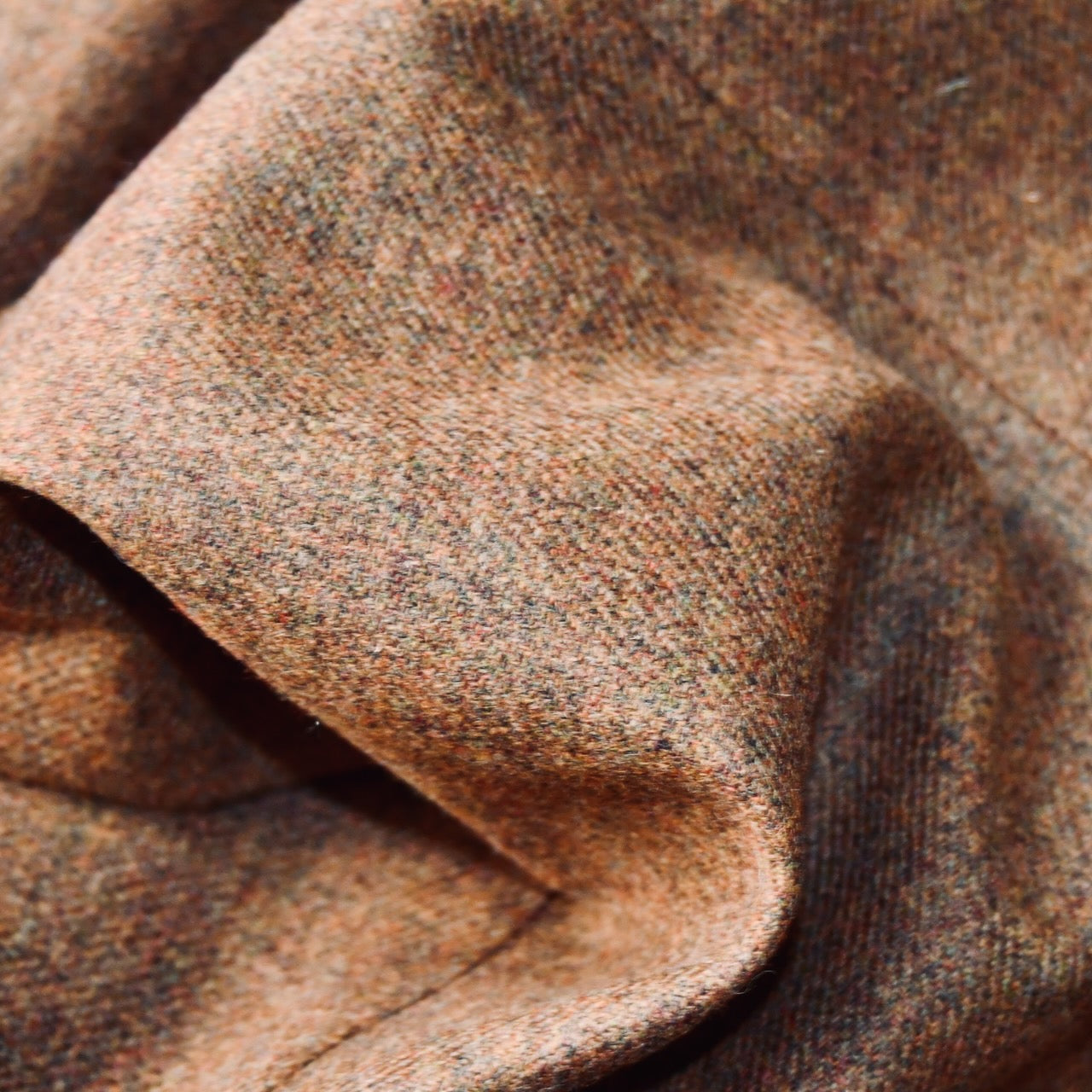 Fabric Close up on Fitted Cut Nehru Style Gilet in Brown finely woven Yorkshire tweed. Handmade in London, this gilet has five buttons to the front, a Nehru collar. three outside and two inside pockets. Smart and wearable in both Town and Country.