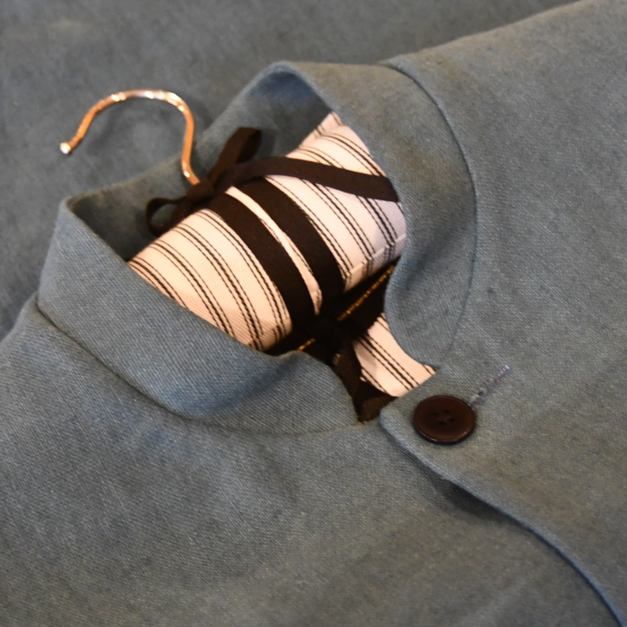 Courtney & Co  Blue Corozo buttons made in Gloucestershire for Bespoke Weskit Gilets. Handmade in London. Shown on Bespoke Blue Irish Linen Waistcoat.