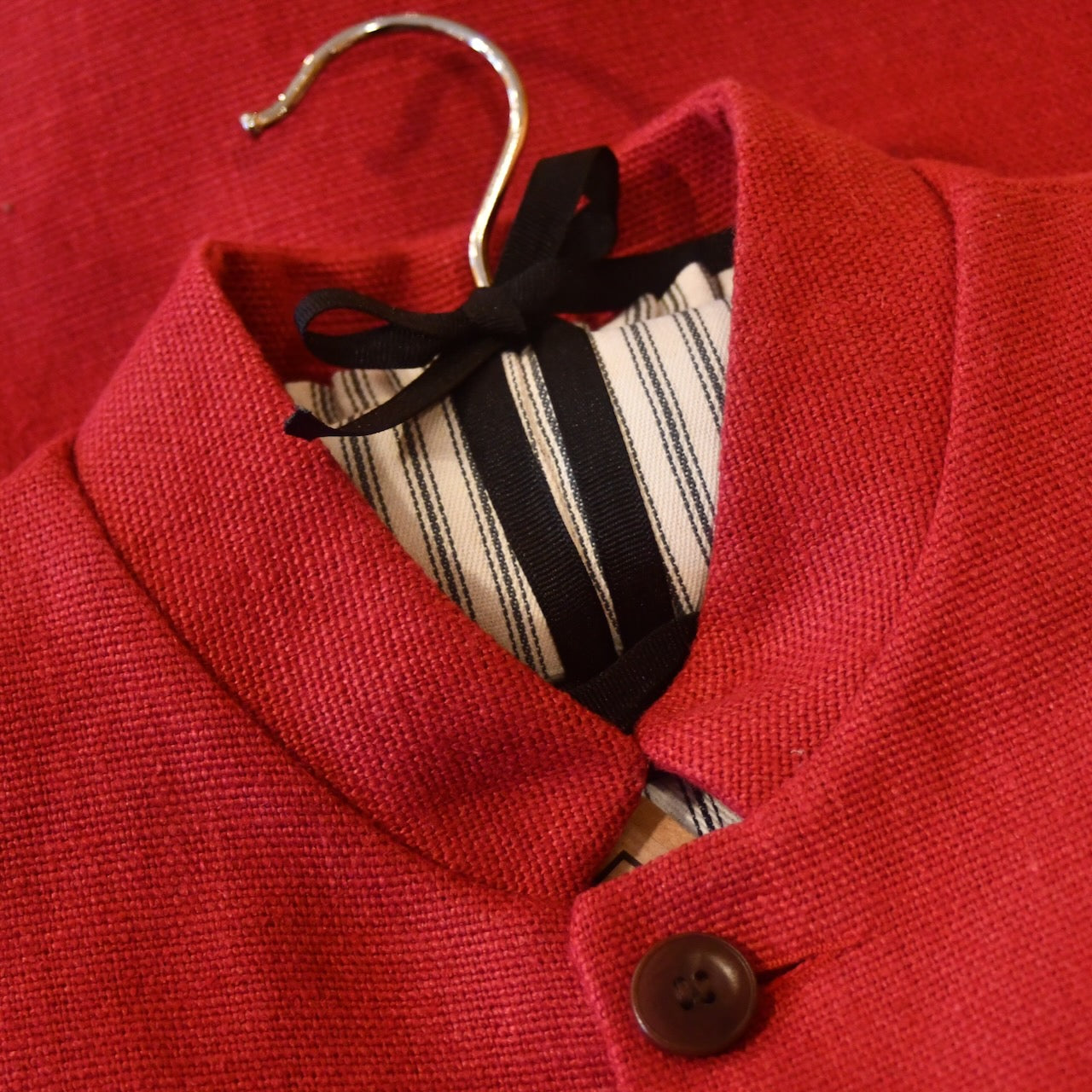 Courtney & Co  Brown Corozo buttons made in Gloucestershire for Bespoke Weskit Gilets. Handmade in London. Shown on Bespoke Red Irish Linen Gilet.