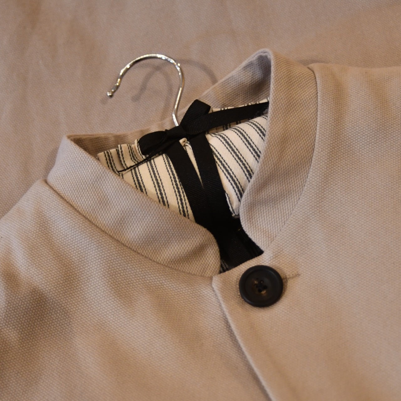 Courtney & Co  Flat Horn buttons made in Gloucestershire for Bespoke Weskit Gilets. Handmade in London. Shown on Bespoke Cotton Canvas Waistcoat.