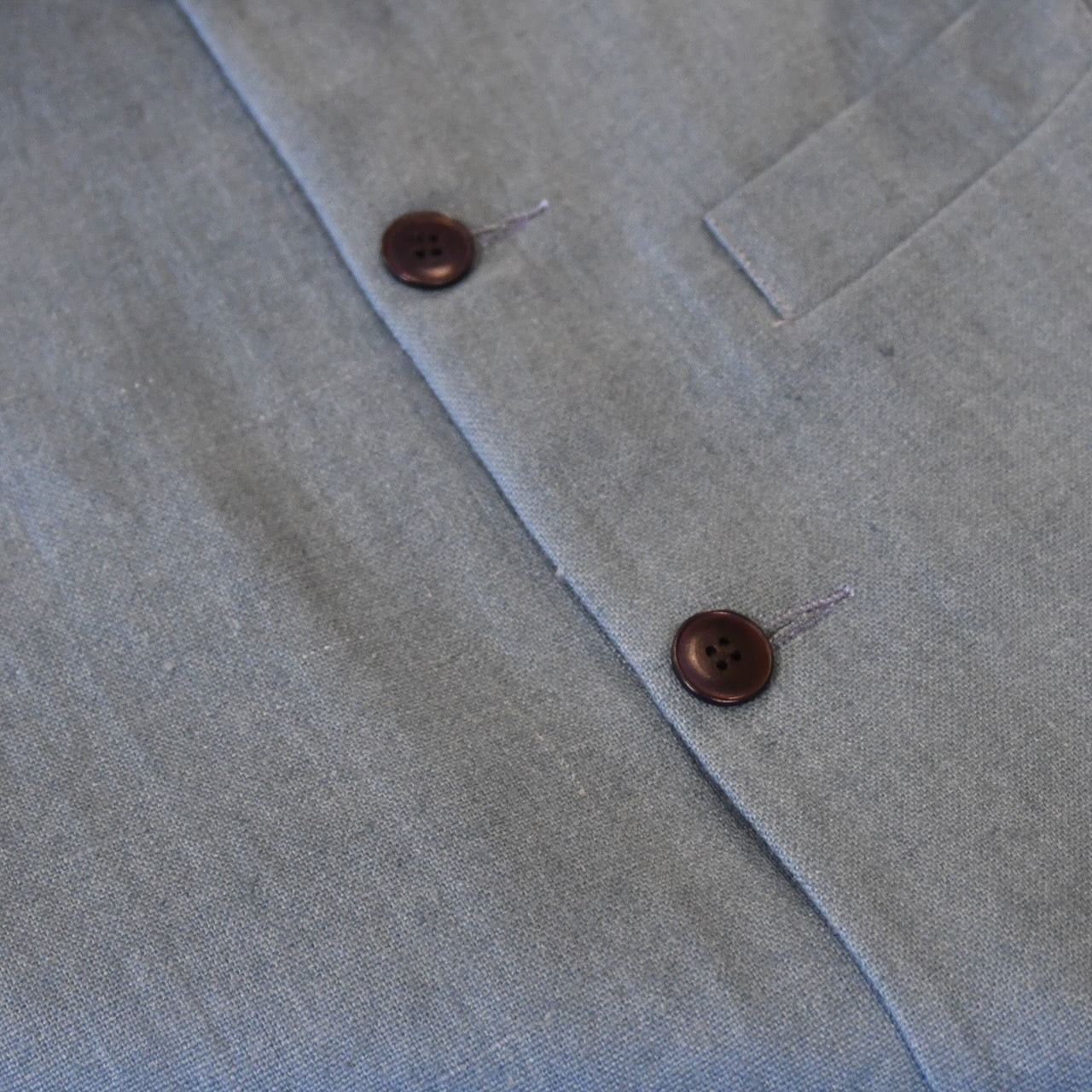Courtney & Co  Blue Corozo buttons made in Gloucestershire for Bespoke Weskit Gilets. Handmade in London. Shown on Bespoke Blue Irish Linen Gilet.