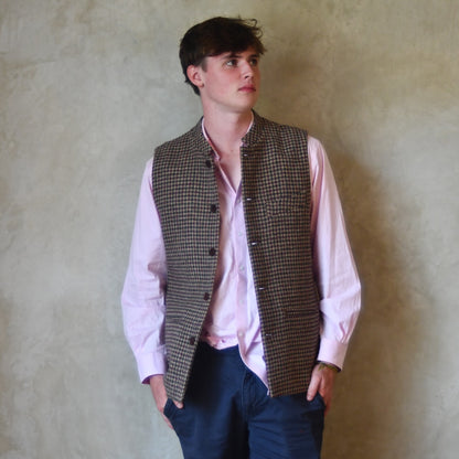 Unbuttoned casual shot of Slim Cut Nehru Style  Gilet in checked pure wool tweed from Lovat Mill. Handmade in London. Worn over pink shirt.
