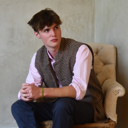 Seated Shot of Slim Cut Nehru Style  Gilet in checked pure wool tweed from Lovat Mill. Handmade in London.