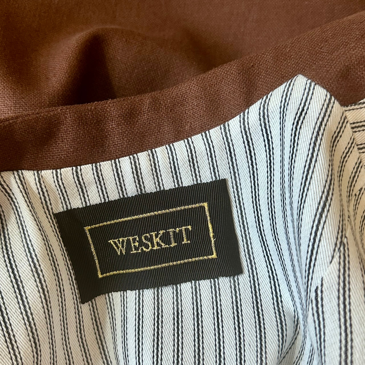 Lining View of Loose fitting summer weight Nehru Style gilet in brown silk matka. Handmade in London. Lined in Cotton Ticking.