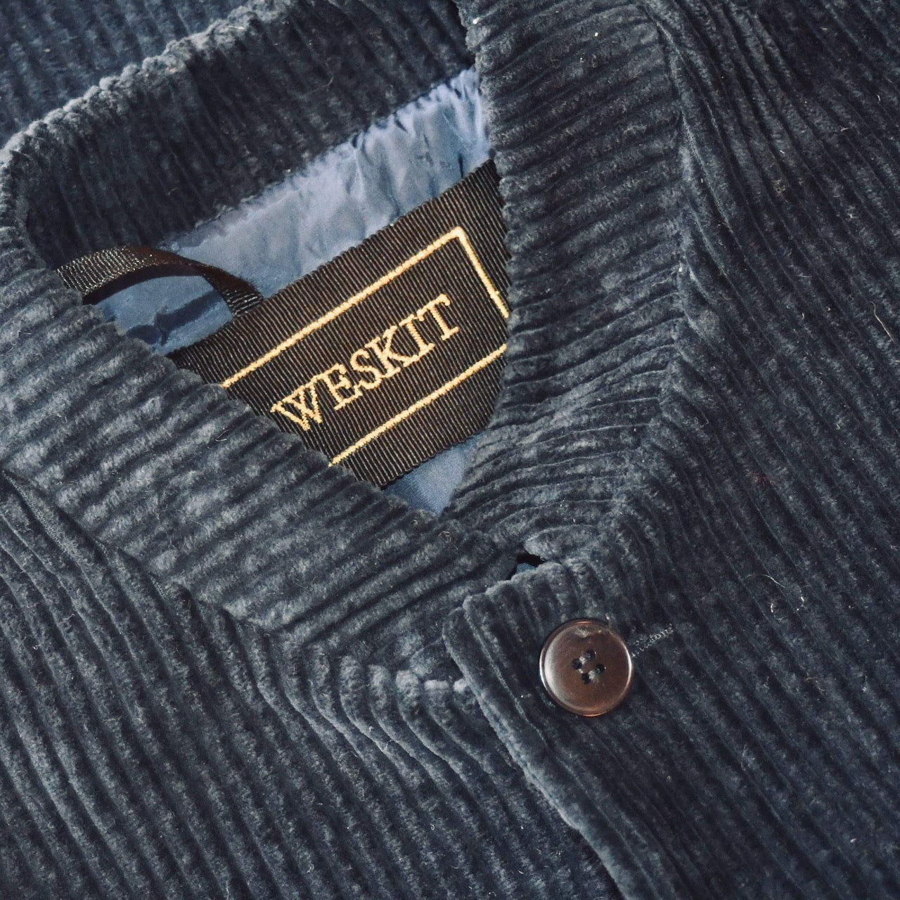 Gilet showing embroidered label and Navy Viscose Lining. Handmade in Britain.