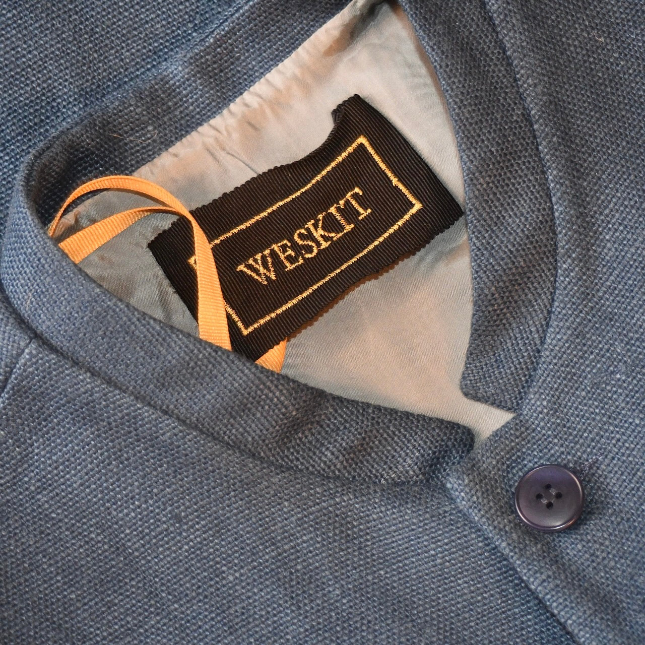 Navy Irish Linen Gilet showing embroidered label and Sand Viscose Lining. Handmade in Britain.