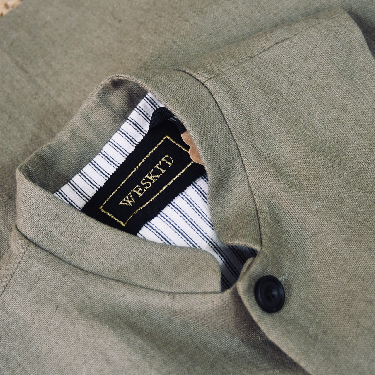 Mandarin Collar detail on Relaxed fit nehru-style gilet in khaki linen. Handmade in London this is a very relaxed waistcoat and a perfect summer alternative to a jacket. Midweight and slubby, the linen outer is fully lined in pure cotton ticking. 