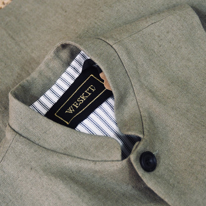 Mandarin Collar detail on Relaxed fit nehru-style gilet in khaki linen. Handmade in London this is a very relaxed waistcoat and a perfect summer alternative to a jacket. Midweight and slubby, the linen outer is fully lined in pure cotton ticking. 