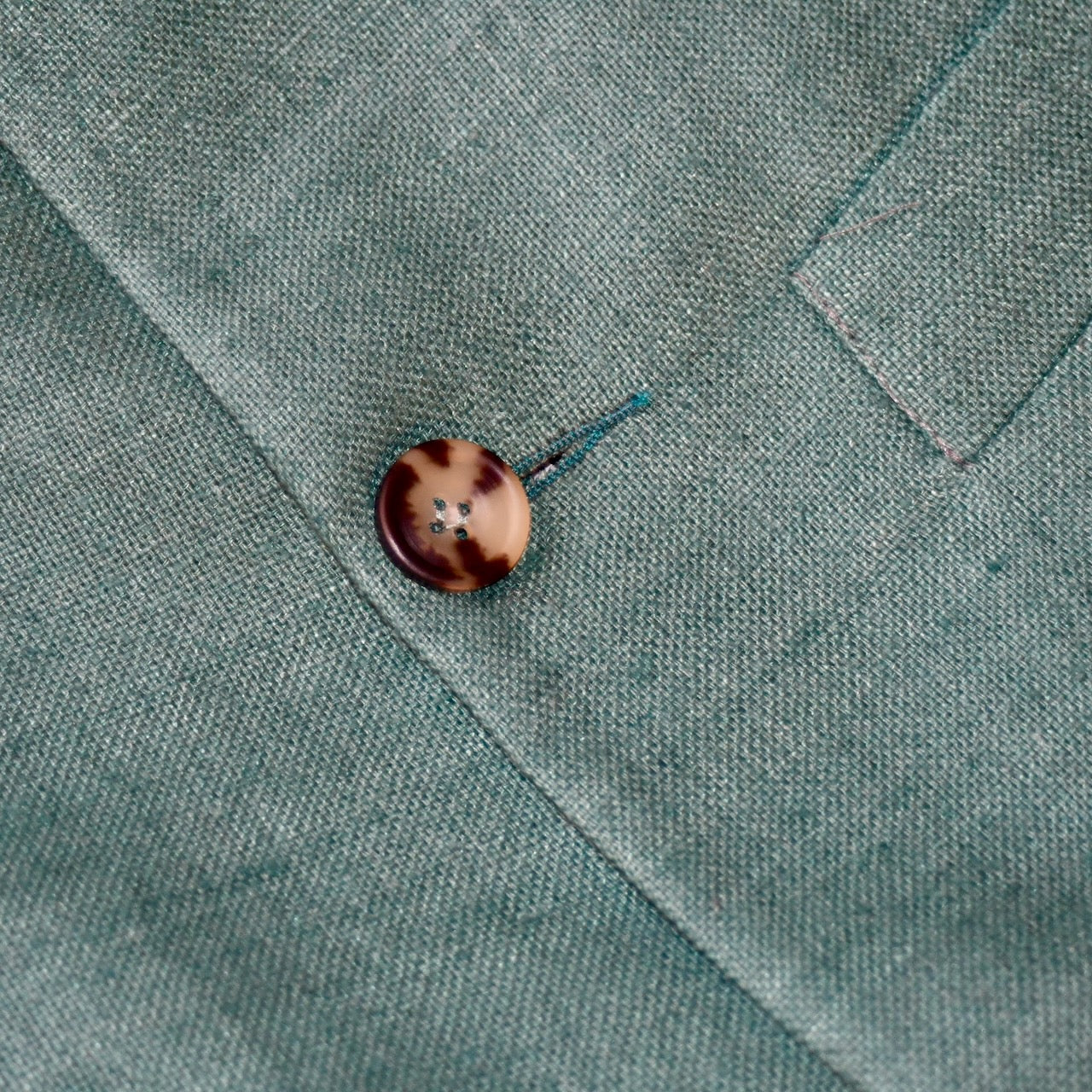 Close up of a superb alternative to a jacket in spring and summer or for evening wear with a neat cut and ample pocket space. This pure silk Nehru Style Gilet is handmade in London. Bespoke Options available.