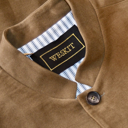Nehru Collar Detail on Slim Cut Nehru Style Gilet in Khaki Moleskin. This pure cotton gilet is lined in striped cotton Ticking. With a Nehru collar and five pockets it will take you everywhere and keep you warm on cooler days. Made by Hand in London.