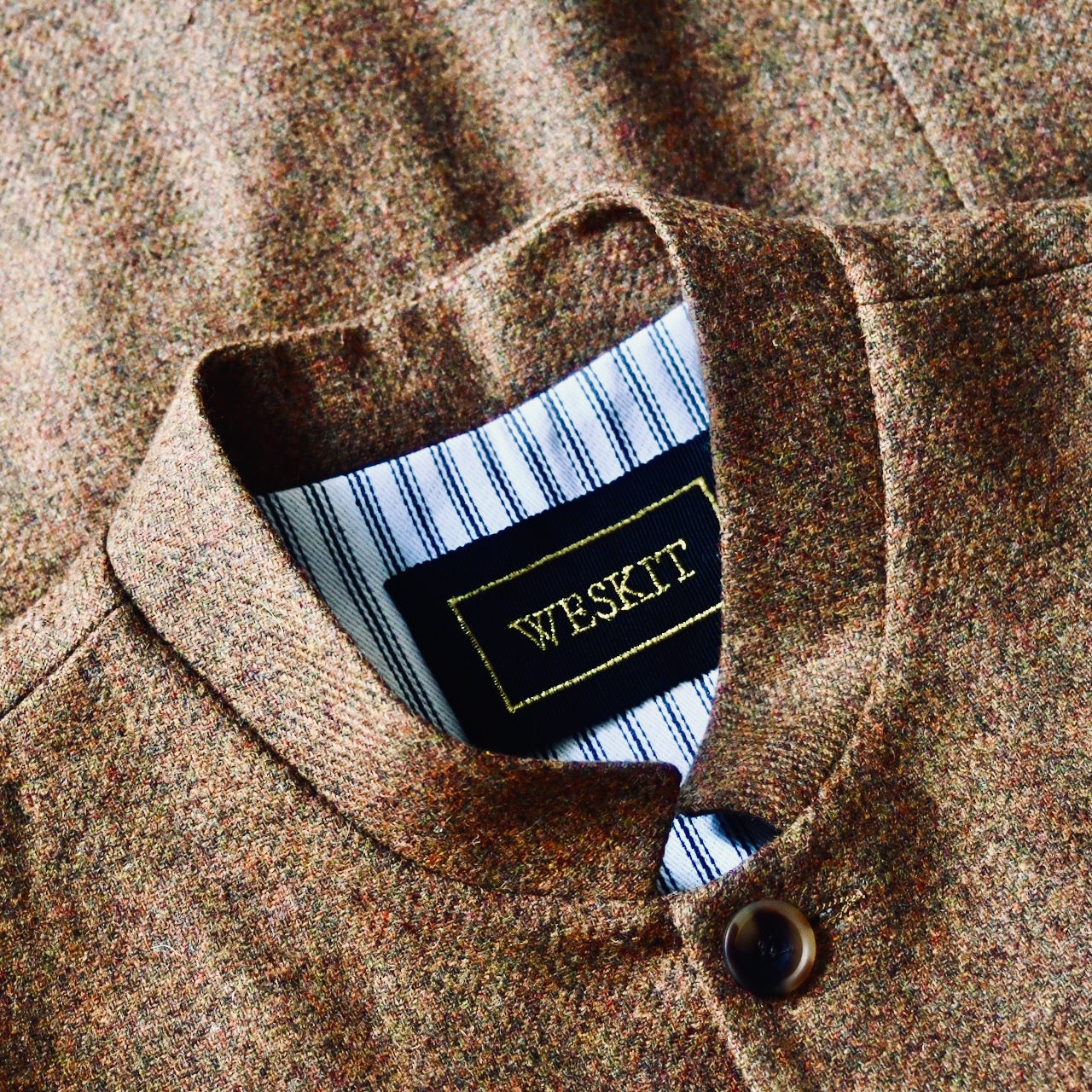 Collar Detail on Fitted Cut Nehru Style Gilet in Brown finely woven Yorkshire tweed. Handmade in London, this gilet has five buttons to the front, a Nehru collar. three outside and two inside pockets. Smart and wearable in both Town and Country.