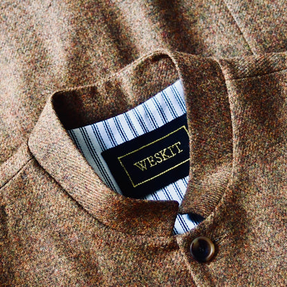 Collar Detail on Fitted Cut Nehru Style Gilet in Brown finely woven Yorkshire tweed. Handmade in London, this gilet has five buttons to the front, a Nehru collar. three outside and two inside pockets. Smart and wearable in both Town and Country.