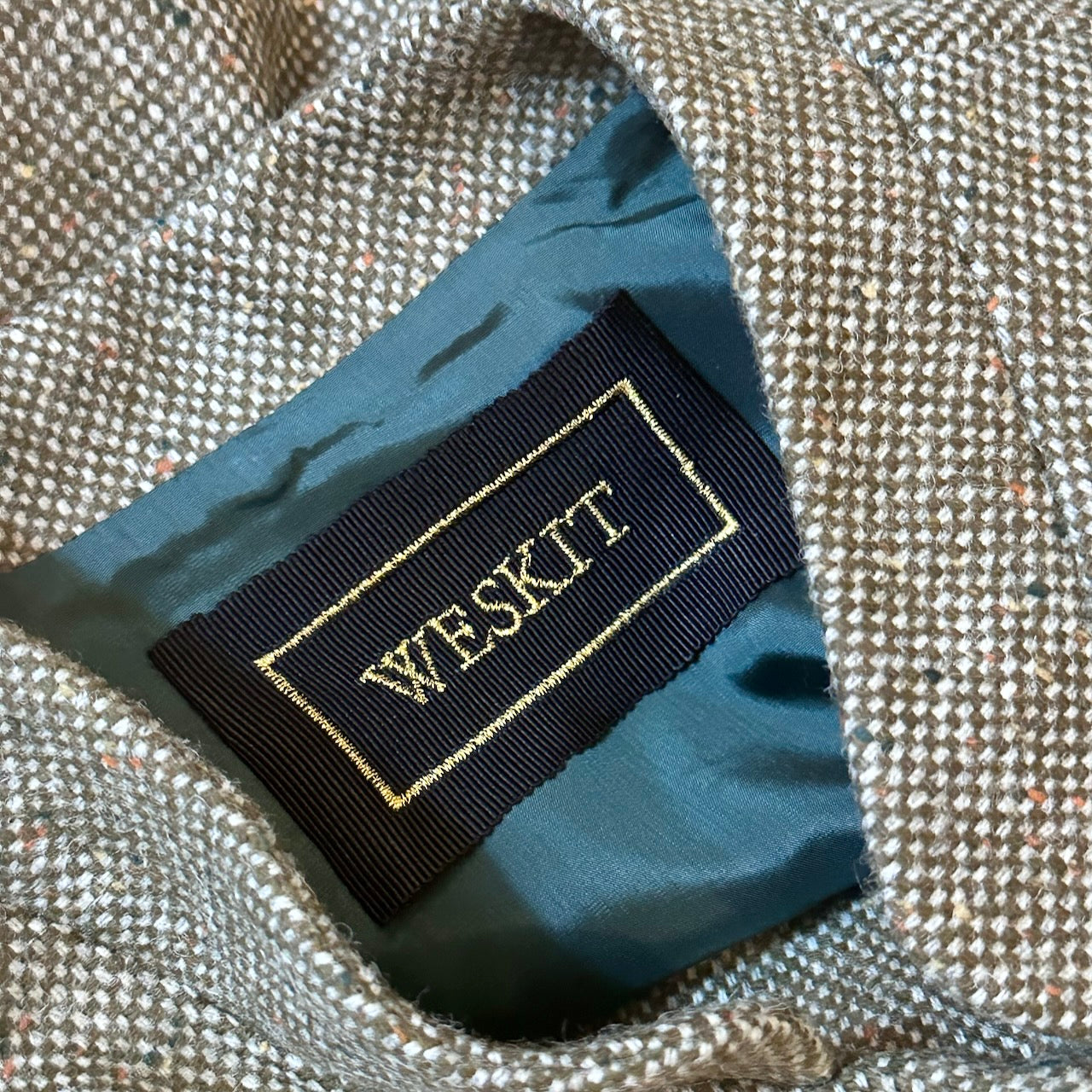 Green Hopsack Gilet showing embroidered label and Bottle Viscose Lining. Handmade in Britain.