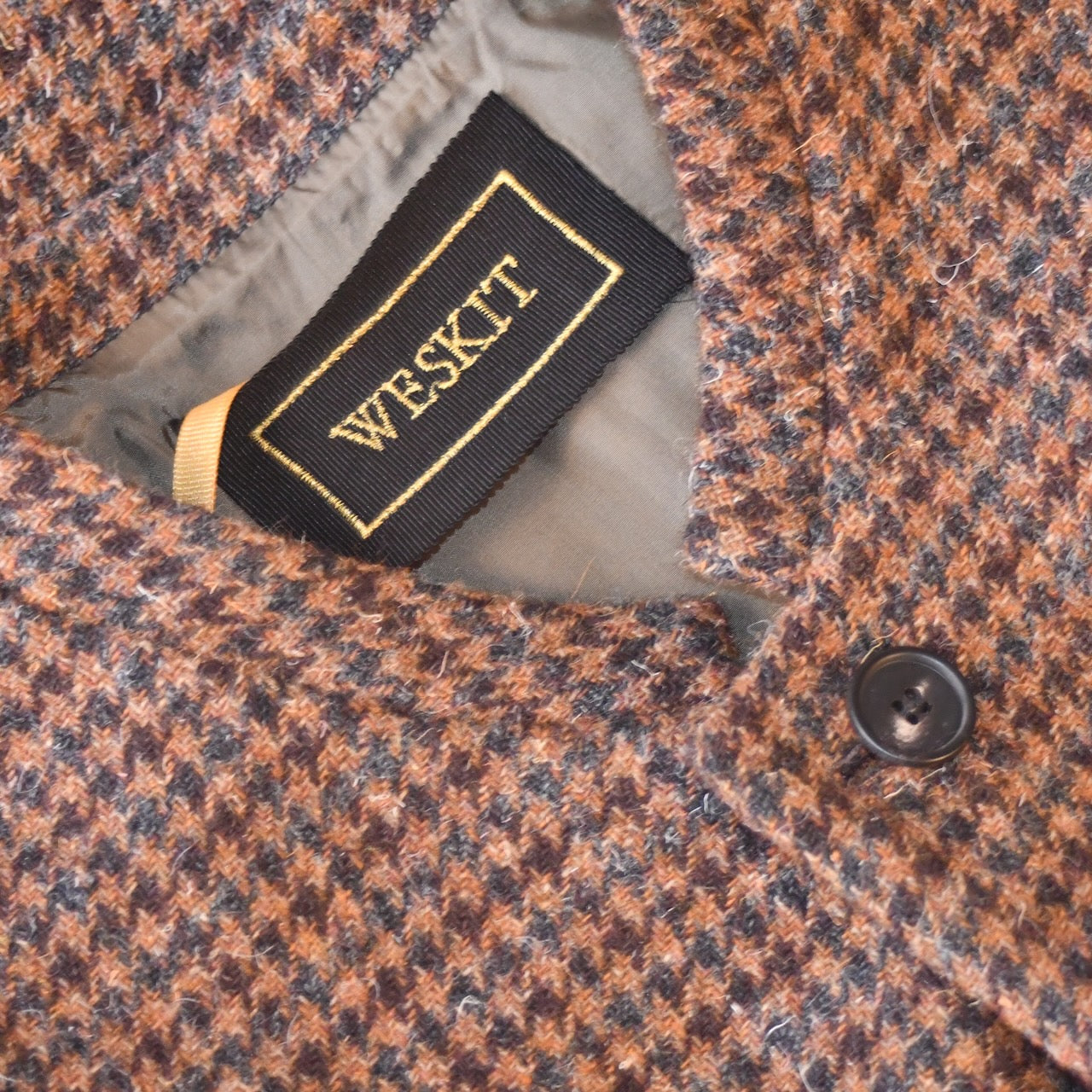 Tweed Gilet showing embroidered label and Dark Brown Viscose Lining. Handmade in Britain.