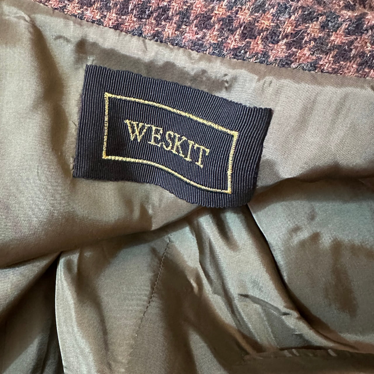 Lining Detail on Fitted Cut Nehru-Style Gilet in Copper Check Lovat Tweed A tailored cut waistcoat imade up in a wonderfully deep coppery checked British Wool tweed by Lovat Mill. An incredibly warm and well-made tweed in a stunning, unusual and very wearable heathery colour which bears green, russet brown, and blue checks against a dark straw background.