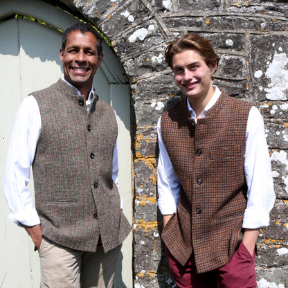 Fitted Cut Nehru-Style Gilet in Copper Check Lovat Tweed A tailored cut waistcoat imade up in a wonderfully deep coppery checked British Wool tweed by Lovat Mill. An incredibly warm and well-made tweed in a stunning, unusual and very wearable heathery colour which bears green, russet brown, and blue checks against a dark straw background. Shown with Small blue lovat check waistcoat.
