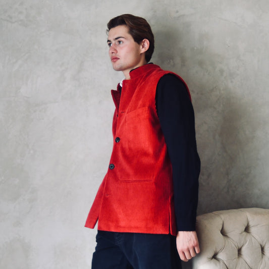 Relaxed Fit Nehru-Style Gilet in Claret Corduroy. This pure cotton corduroy gilet is lined in striped cotton ticking. With a Nehru collar and five pockets it can be dressed up or down. Two side lits for comfort. Handmade in London. Side on View.