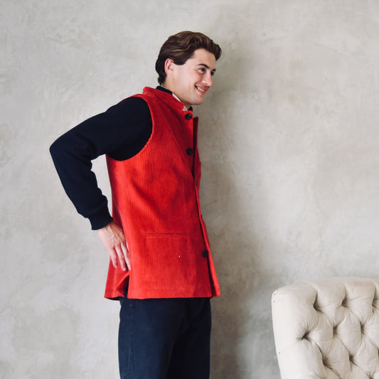 Relaxed Fit Nehru-Style Gilet in Claret Corduroy. This pure cotton corduroy gilet is lined in striped cotton ticking. With a Nehru collar and five pockets it can be dressed up or down. Two side lits for comfort. Handmade in London. Side View.