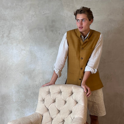 Tan coloured slim fit gilet in a summer weight silk weave. Handmade in London this fitted waistcoat has five pockets and a Nehru collar. Made in Great Britain. Standing shot.