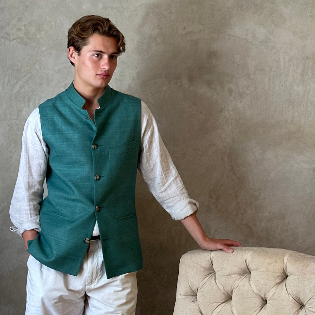 A superb alternative to a jacket in spring and summer or for evening wear with a neat cut and ample pocket space. This pure silk Nehru Style Gilet is handmade in London. Bespoke Options available. Modelled Standing Shot.