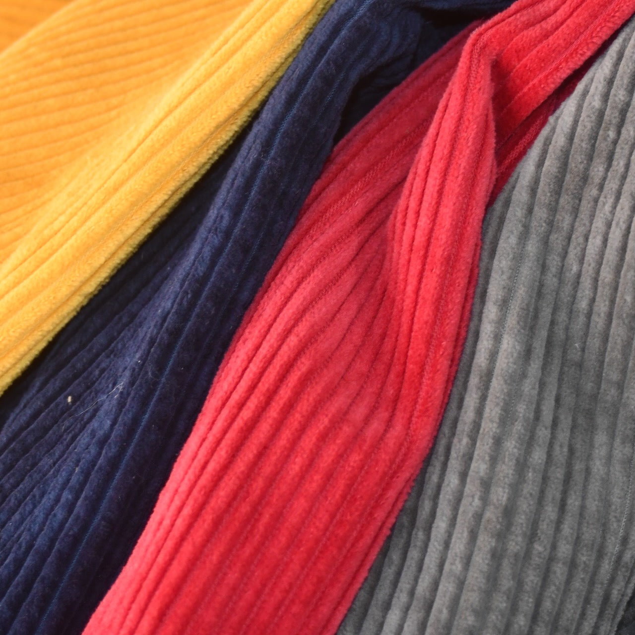 Corduroy fabrics in ochre, navy, red and khaki for Bespoke Weskit Waistcoats. Made by hand in London.
