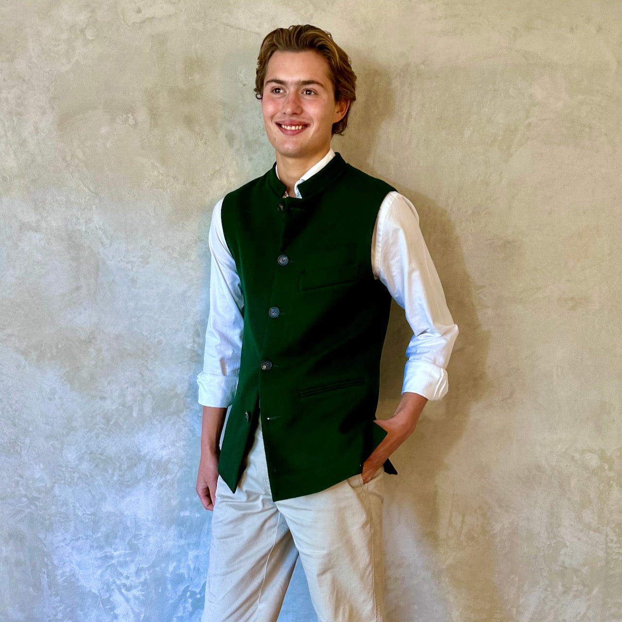 Slim Cut Nehru Style Gilet in bottle or British racing green pure merino flannel. This pure wool gilet is hand made in London. The thick merino wool flannel is woven in Yorkshire by AW Hainsworth. A perfect Town-to-Country dressing solution.