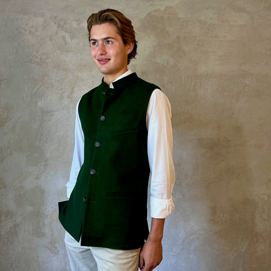 Slim Cut Nehru Style Gilet in bottle or British racing green pure merino flannel. This pure wool gilet is hand made in London. The thick merino wool flannel is woven in Yorkshire by AW Hainsworth. A perfect Town-to-Country dressing solution. Side View.