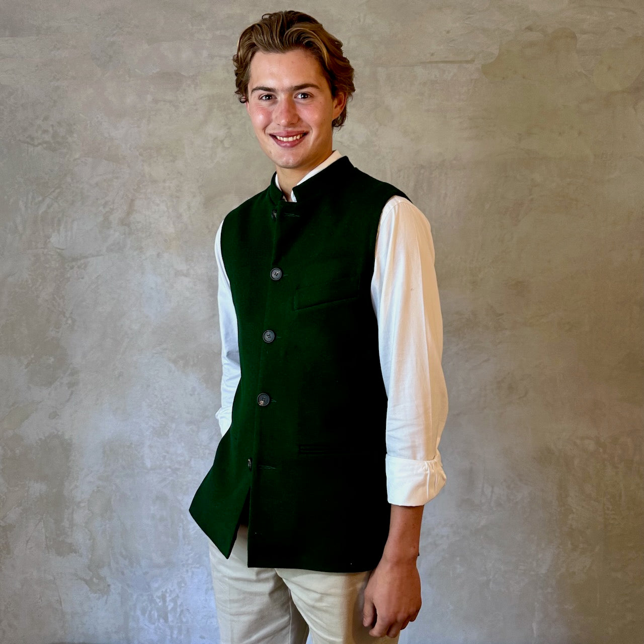 Slim Cut Nehru Style Gilet in bottle or British racing green pure merino flannel. This pure wool gilet is hand made in London. The thick merino wool flannel is woven in Yorkshire by AW Hainsworth. A perfect Town-to-Country dressing solution. Buttoned View.