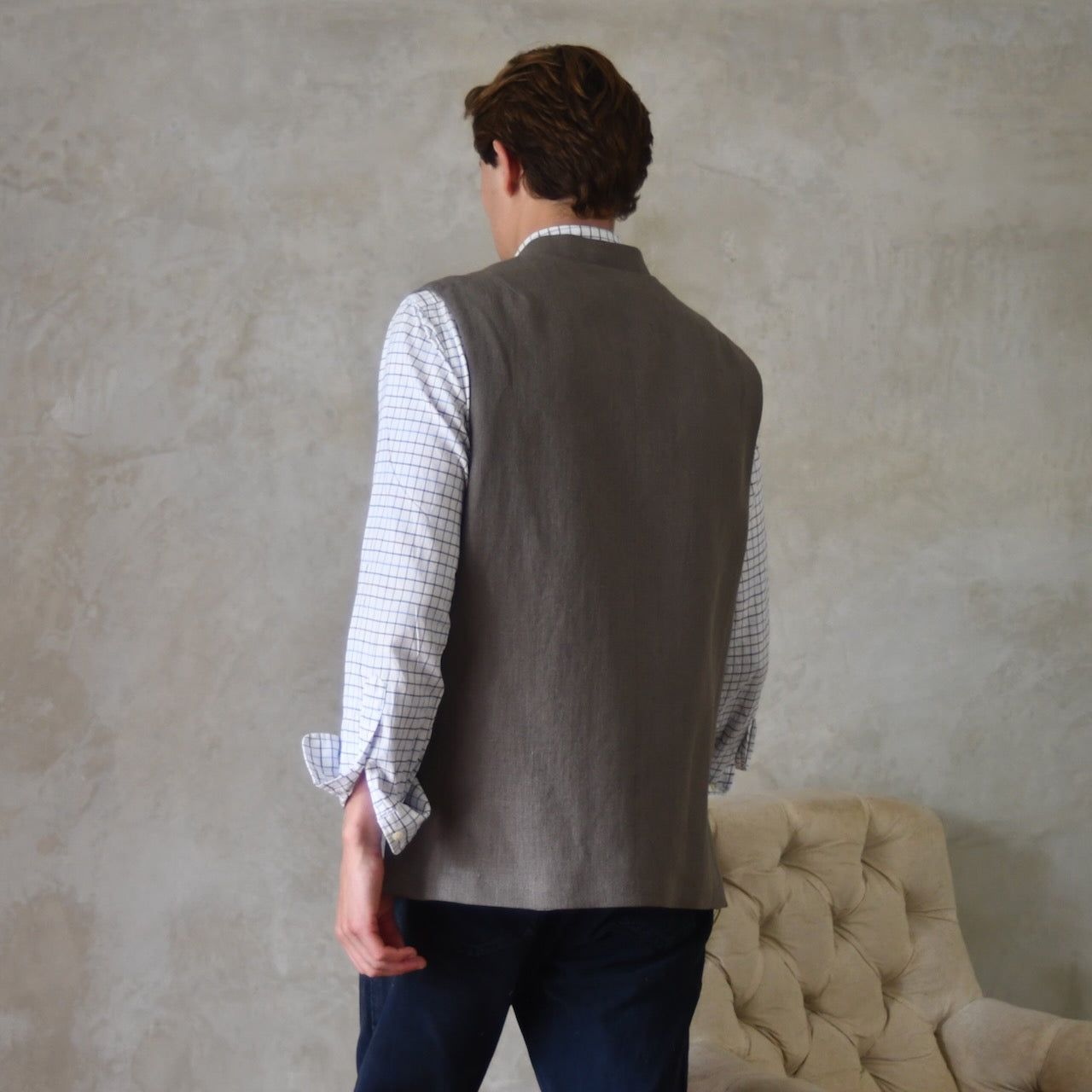 Spring summer relaxed fit Nehru style gilet in slubby Irish linen. This browning coloured linen waistcoat is fully lined in pure cotton ticking. With three outside and two inside pockets it is the perfect alternative to a jacket on warmer days.  Rear view. Handmade in London.