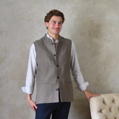 Spring summer relaxed fit Nehru style gilet in slubby Irish linen. This browning coloured linen waistcoat is fully lined in pure cotton ticking. With three outside and two inside pockets it is the perfect alternative to a jacket on warmer days. 