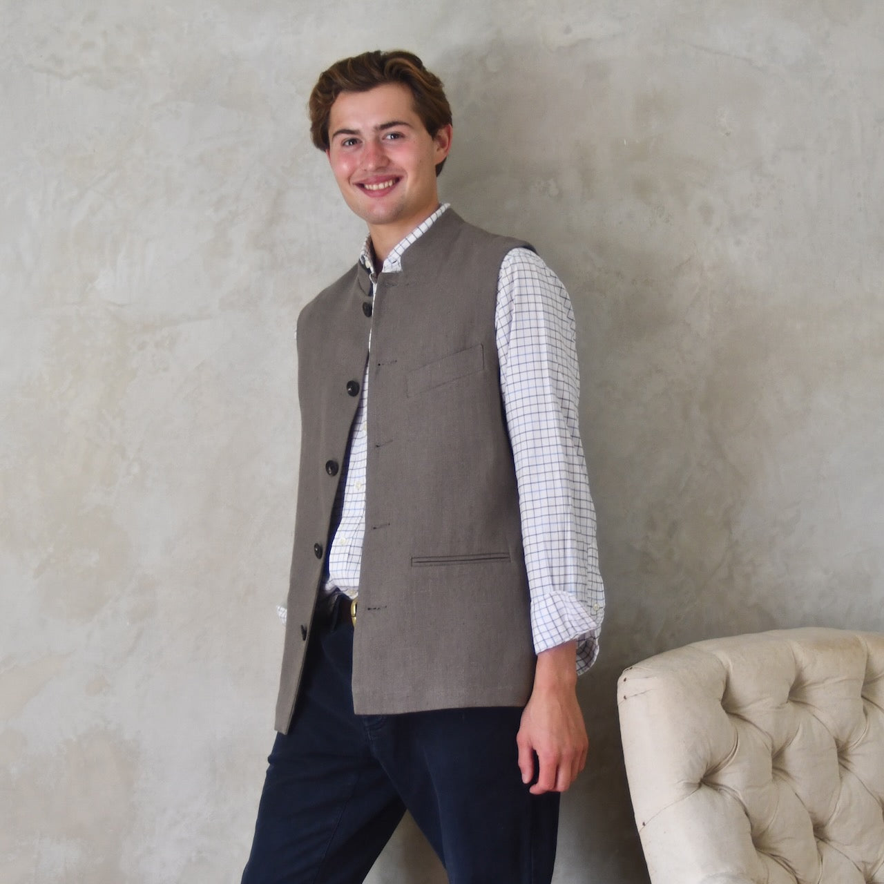 Nehru-style fitted gilet in relaxed brown Irish linen. Handmade in London this slim-cut waistcoat has a Nehru collar, is fully lined in pure cotton ticking and has five pockets. Standing open shot.