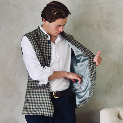 A magnificent and truly luxurious Nehru-Style Gilet in Fox Brothers Green GunClub Check Flannel. Woven in Somerset and Handmade in London, this is the ultimate statement gilet and the top notch in British-made luxury.