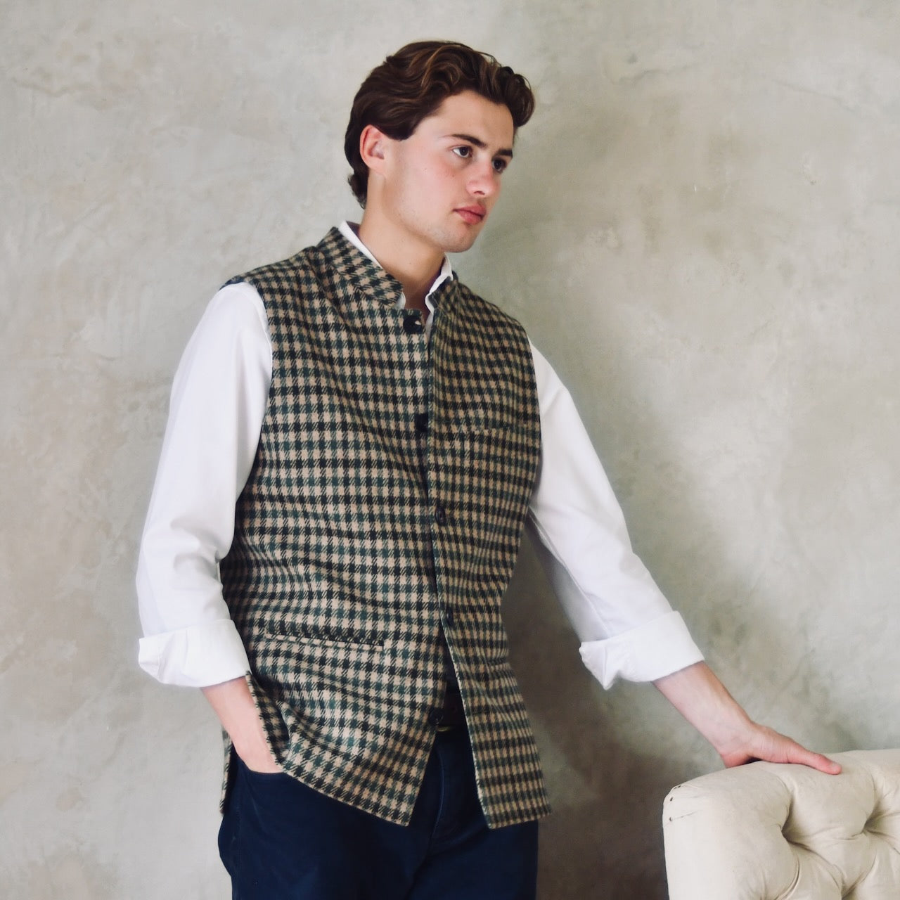 A magnificent and truly luxurious Nehru-Style Gilet in Fox Brothers Green GunClub Check Flannel. Woven in Somerset and Handmade in London, this is the ultimate statement gilet and the top notch in British-made luxury. With five pockets and side vents, this gilet screams elegance.