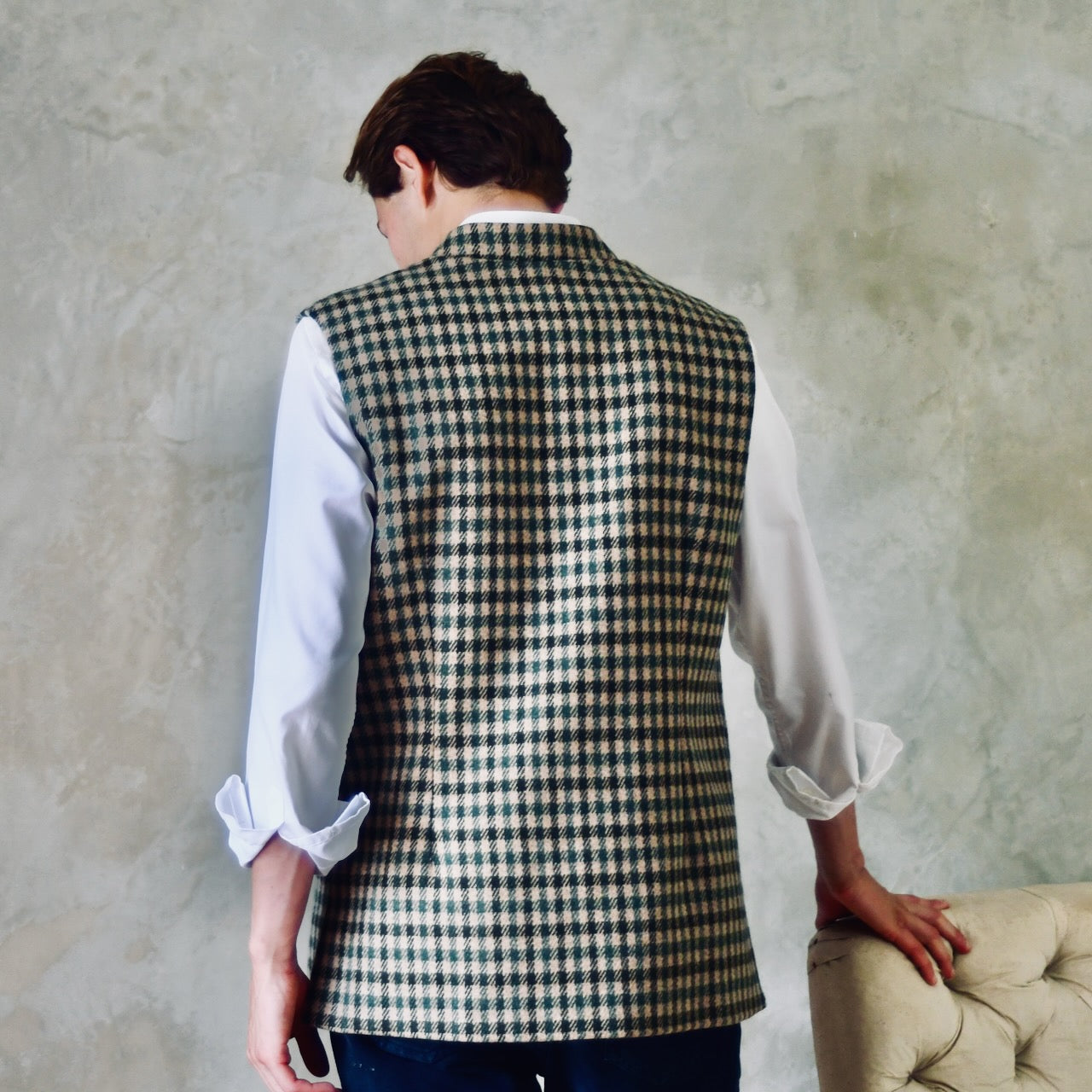 A magnificent and truly luxurious Nehru-Style Gilet in Fox Brothers Green GunClub Check Flannel. Woven in Somerset and Handmade in London, this is the ultimate statement gilet and the top notch in British-made luxury. Back shot showing rear darts and side vents.