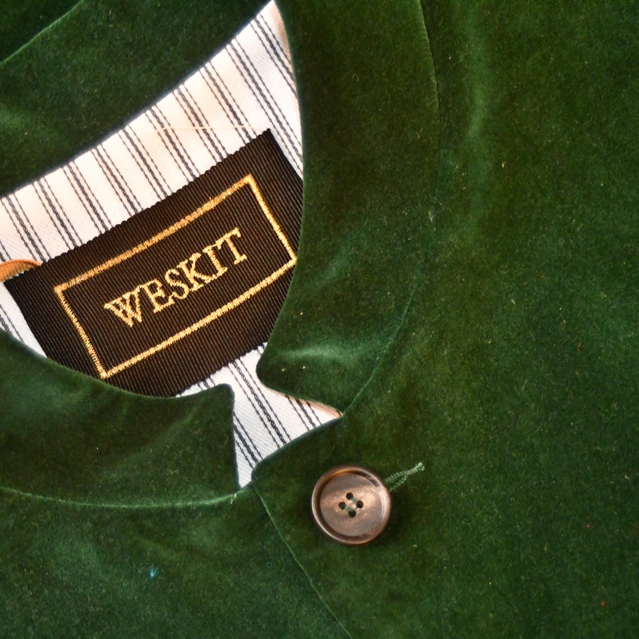 Embroidered Silk Label shown on Weskit Gilet with bottle green velvet outer on cotton ticking striped lining. Handmade in Great Britain.