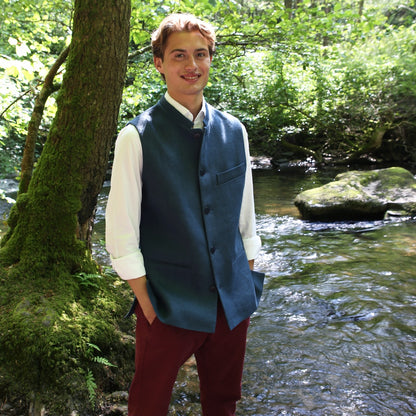 Relaxed Fit Nehru Style Gilet in Heavy Blue Linen. Irish Linen Gilet, Made by Hand in London. Entirely made in Great Britain. Seated Shot by a river in Wales,