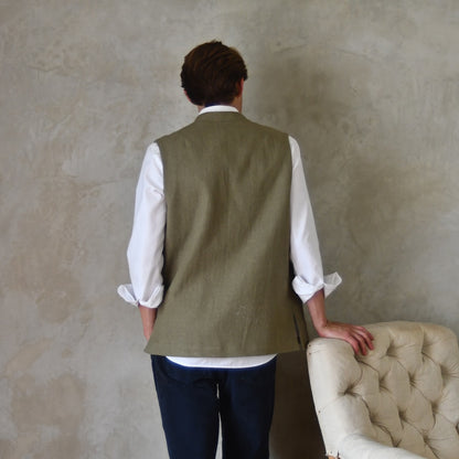Relaxed fit nehru-style gilet in khaki linen. Handmade in London this is a very relaxed waistcoat and a perfect summer alternative to a jacket. Midweight and slubby, the linen outer is fully lined in pure cotton ticking.  Shot showing Rear View.