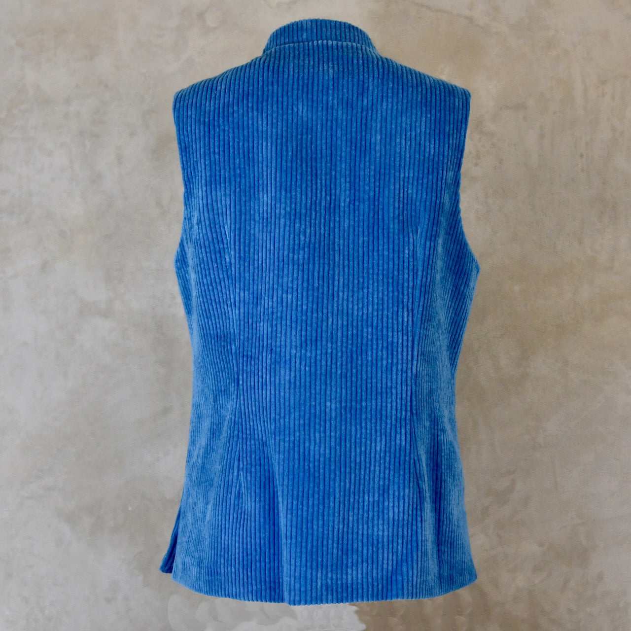 Rear View of Blue Cotton Corduroy Ladies Waistcoat. 
Handmade in London this longer length Gilet has a Nehru collar and bllue corozo buttons.